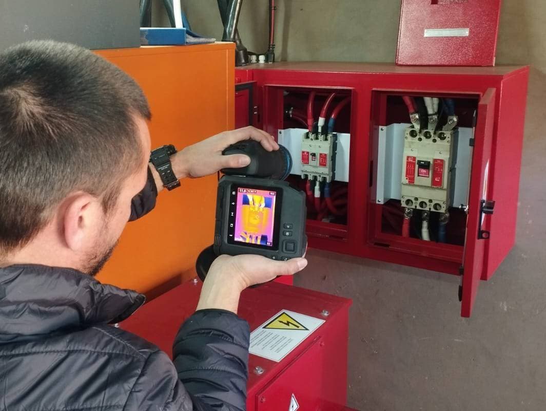 Thermography solutions and services in South Africa, technician scanning a distribution board